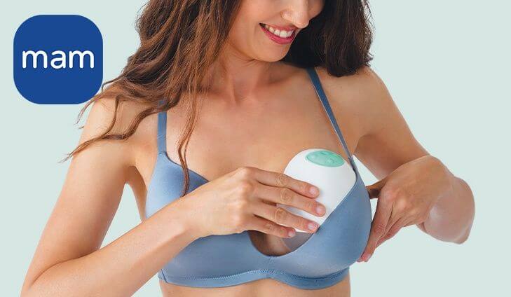 Woman using a MAM baby breast pump